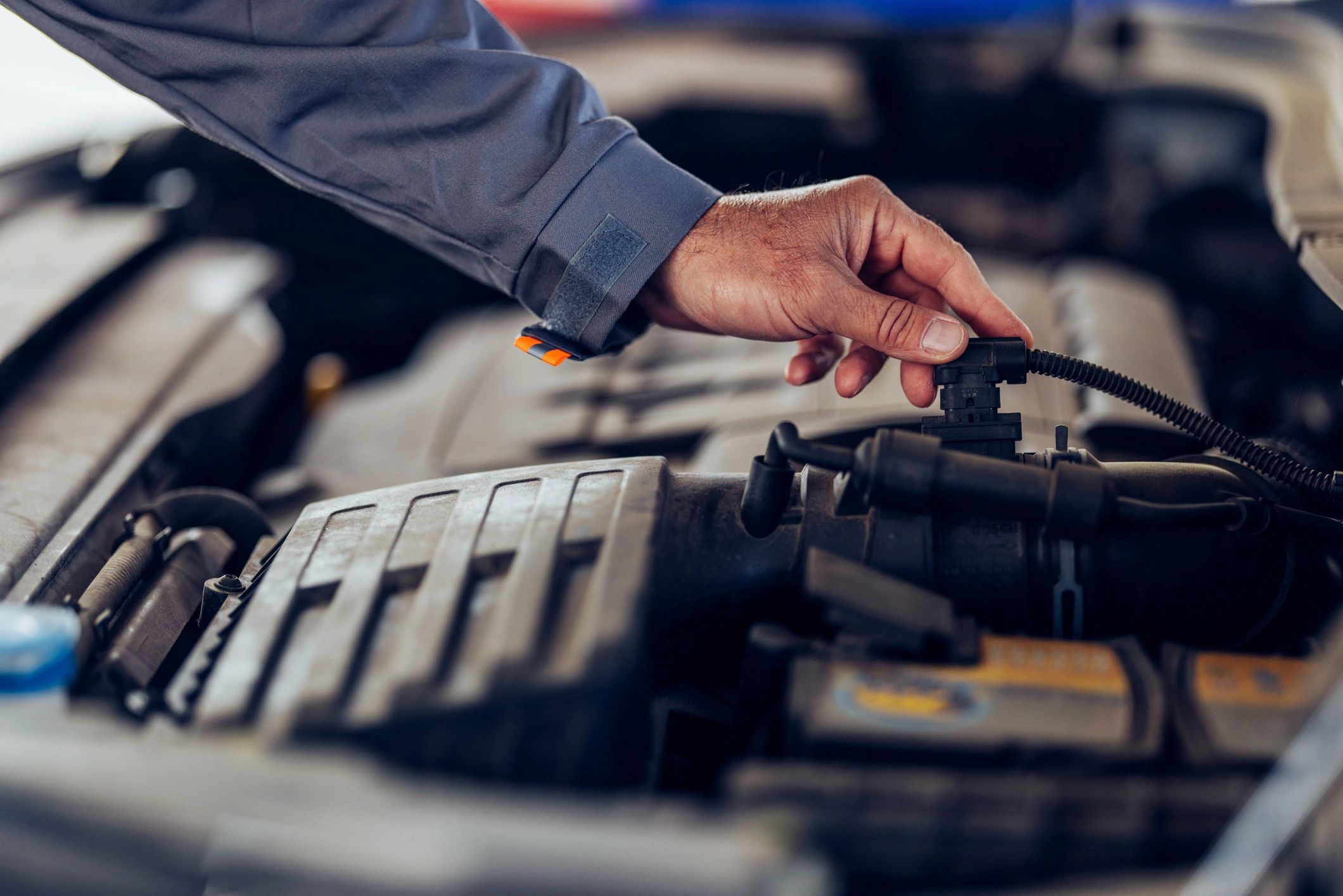 Mechanic inspecting a car engine during diagnostics