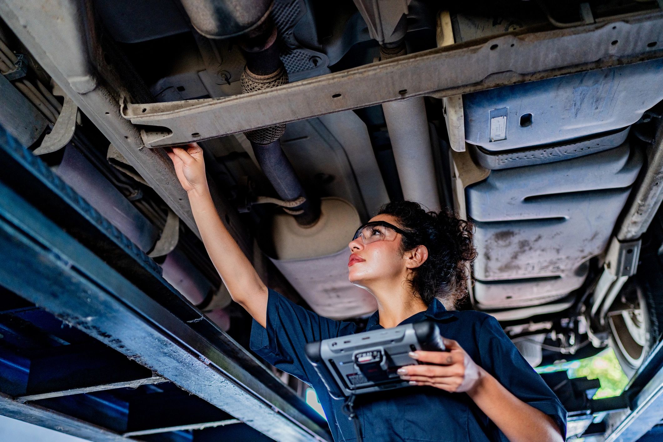 Mechanic inspecting a vehicle at Magnum Motors LLC
